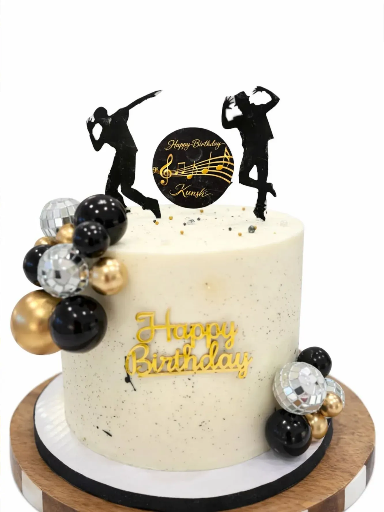 Ivory cake speckled with gold, trimmed with a cluster of black, gold and mirrored disco spheres, topped with dancer silhouettes and a musical-note disc.